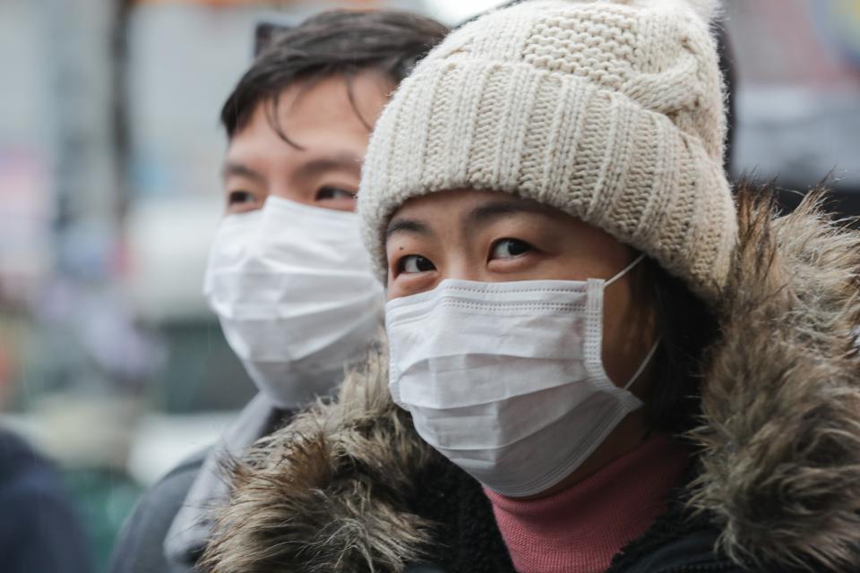 people wearing face masks to combat coronavirus covid-19